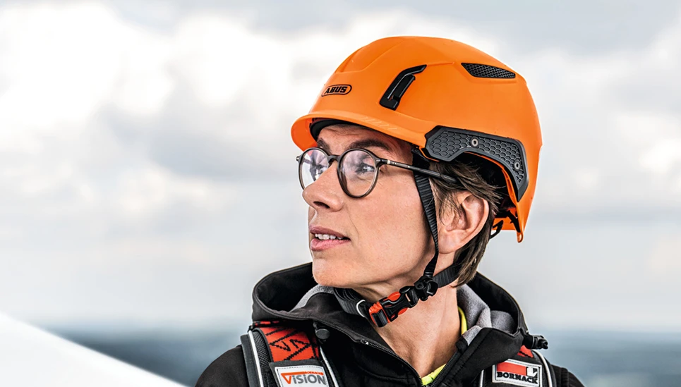 Woman wearing Spector safety helmet on which the ventilation ducts and openings in honeycomb structure can be seen © ABUS