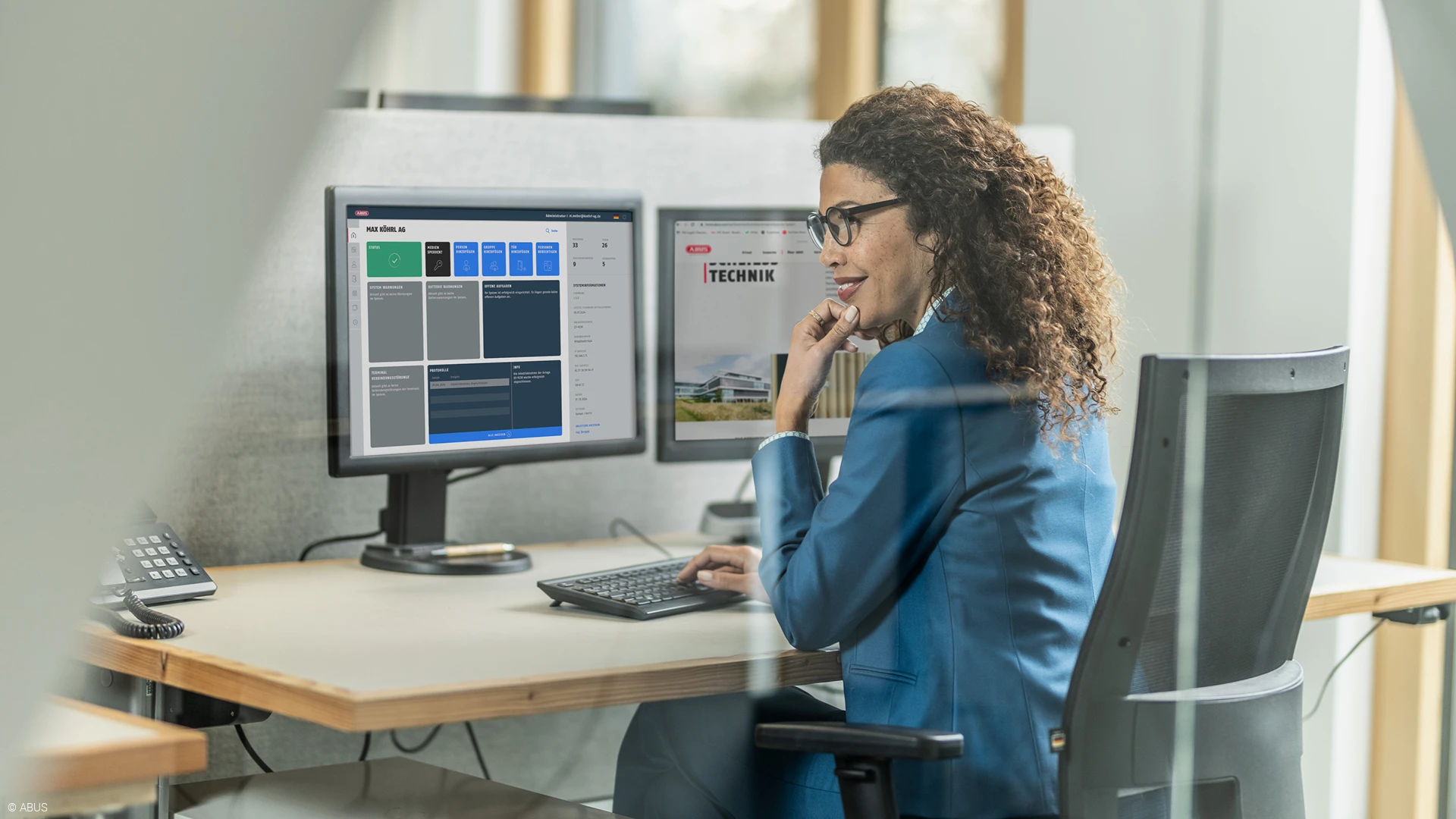 A woman sits in front of a monitor showing a TECTIQ locking plan.